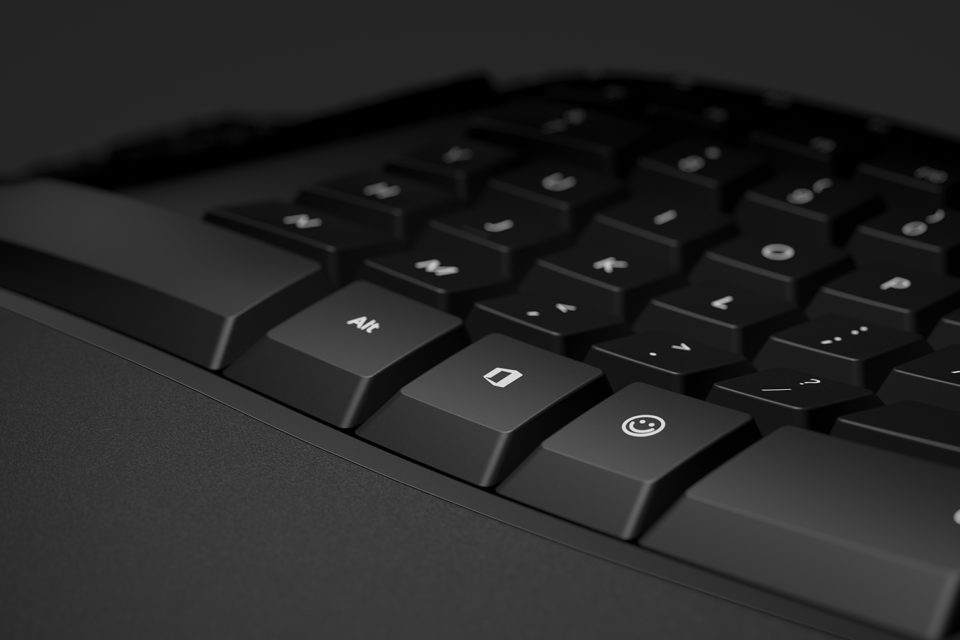 A keyboard containing an "emoji" key