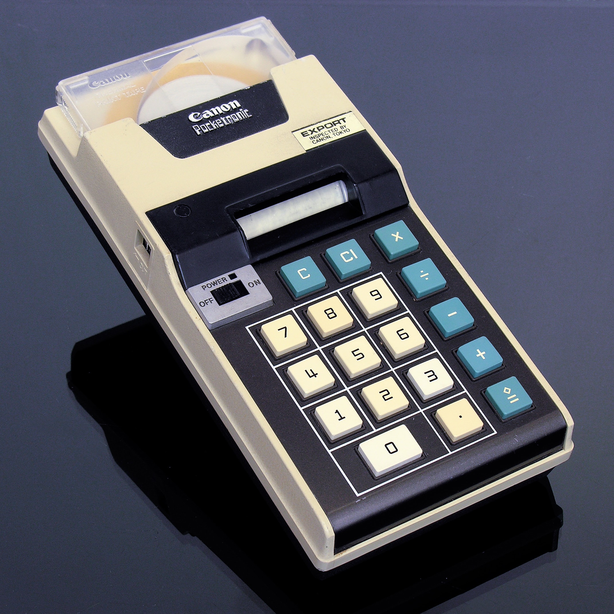 The Canon Pocketronic, a beige and black printing calculator based on a Texas Instruments prototype.